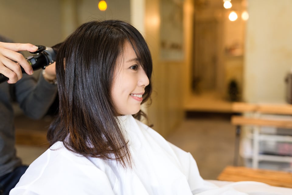 Woman Having Haircut in Salon